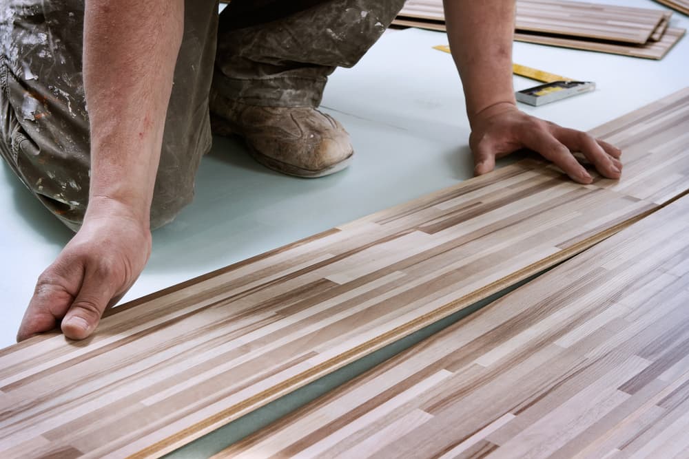 Man installing tongue-and-groove flooring