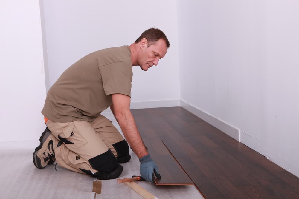 A man installing floating floor